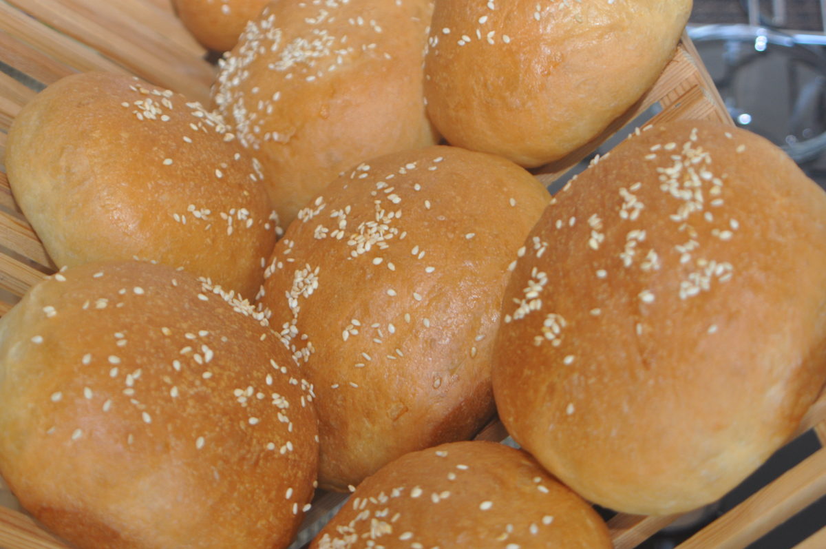 Burger buns on a rack.