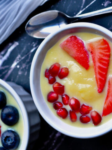 indian custard in a bowl with fruits.