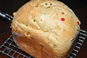 Tutti frutti whole bread on a cooling rack.