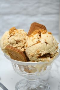 Biscoff ice cream scoops in a glass bowl.