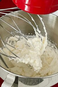 Whipped cream in stand mixer.