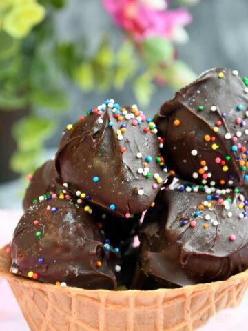 Frozen chocolate covered strawberries in a waffle cup.