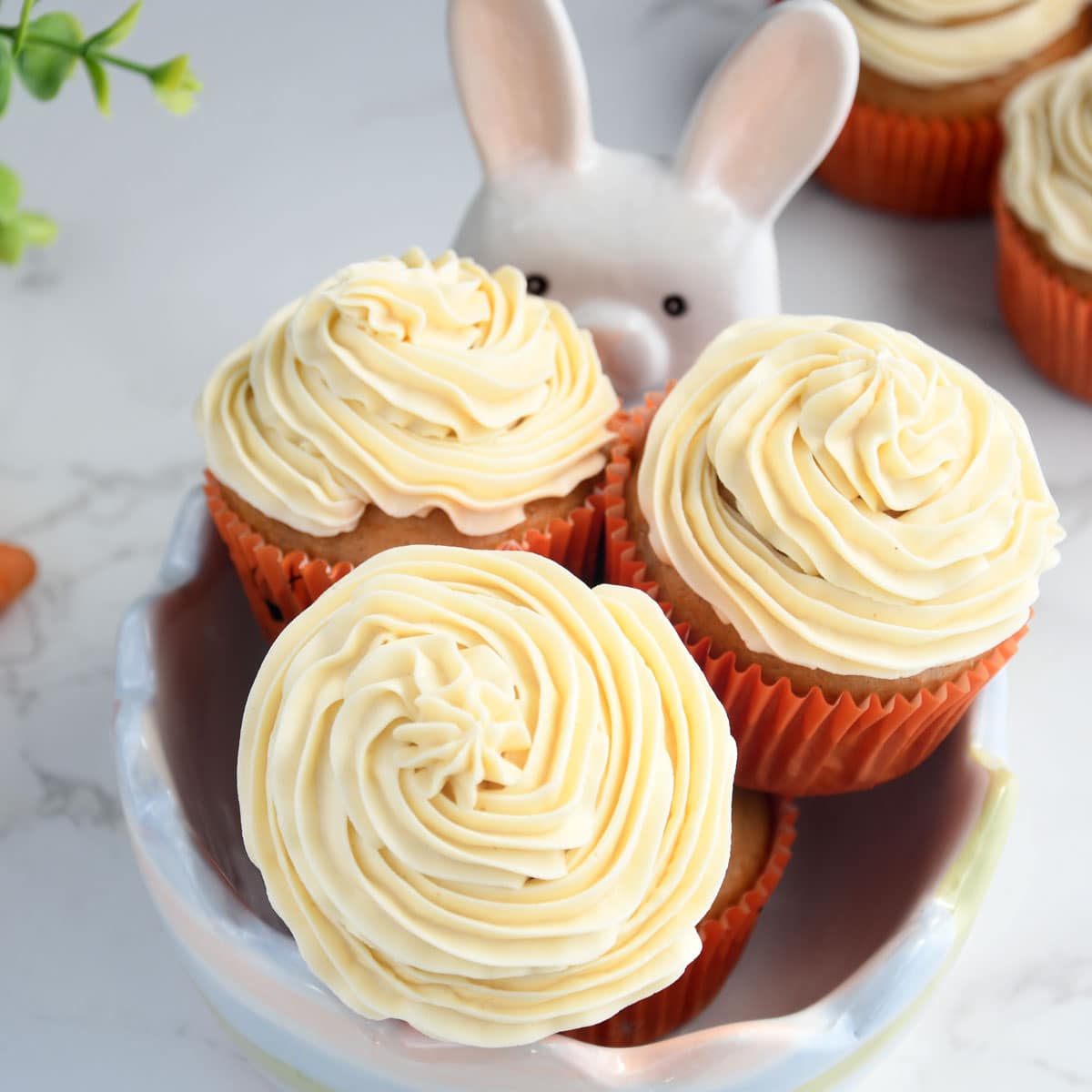 Carrot cupcakes in a decorative bowl.