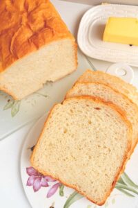 Slices of Greek Yougurt Bread on a platter with butter on the side.