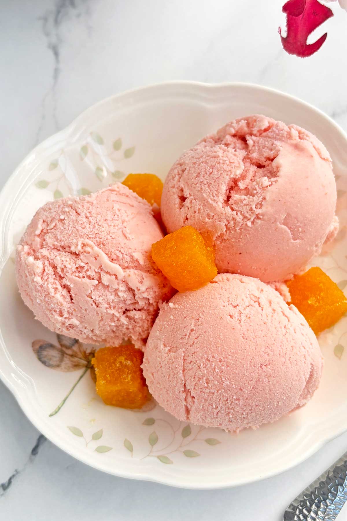 Strawberry and Passion fruit icecream scoops in dessert plate.