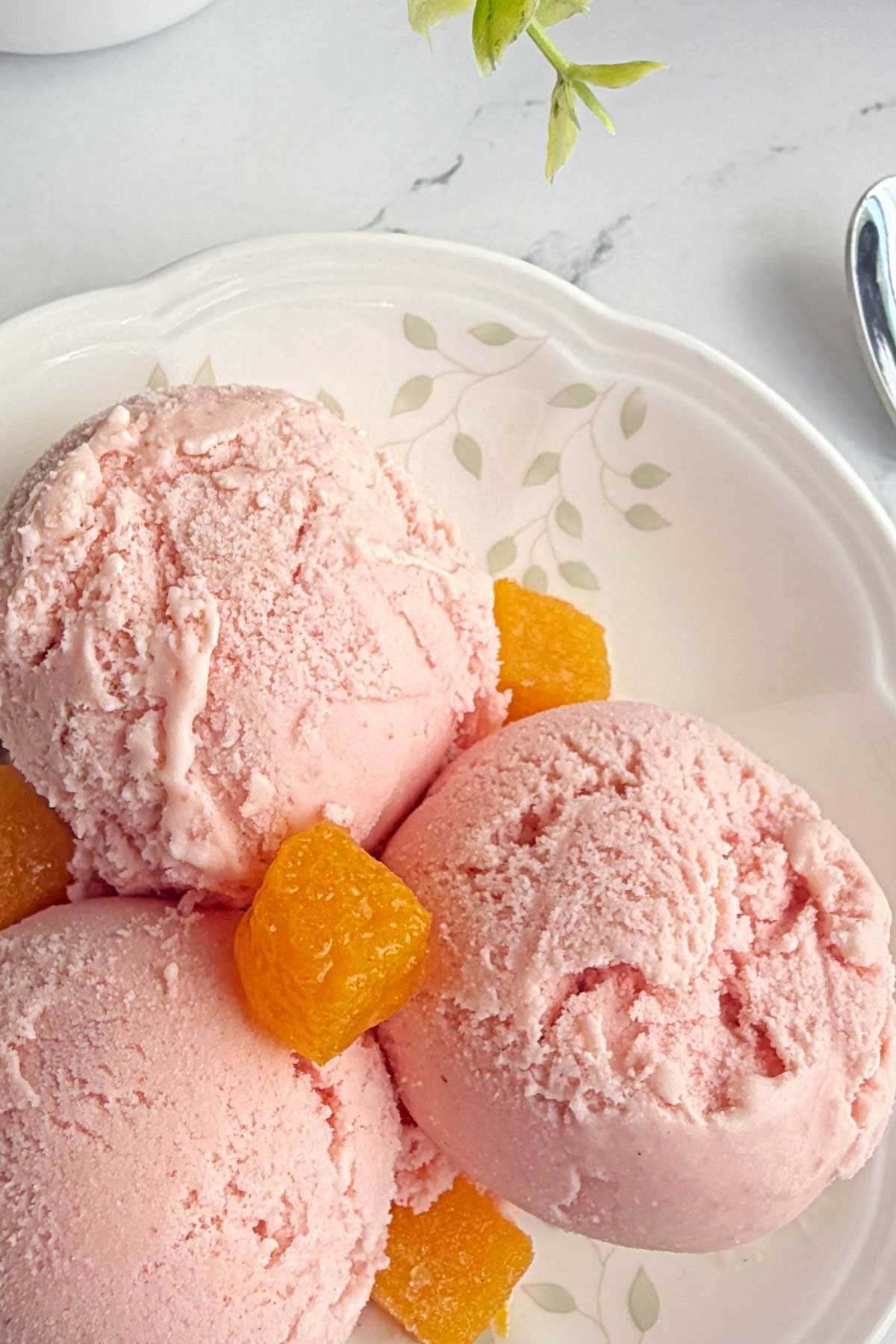 Strawberry and Passion fruit icecream scoops in dessert plate.