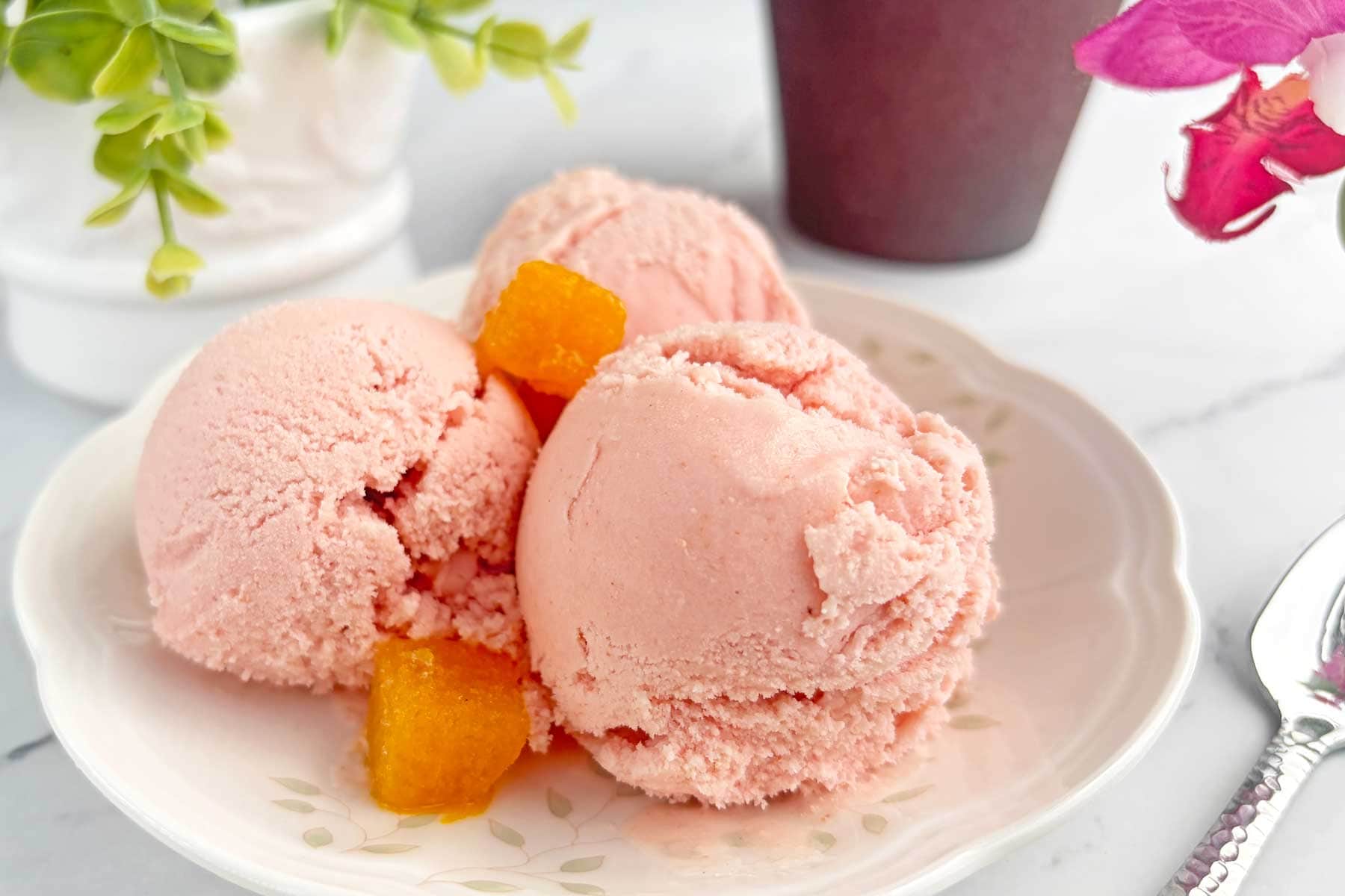 Strawberry and Passion fruit icecream scoops in dessert plate.