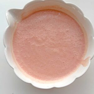 Strawberry and Passion fruit icecream mixture in a bowl.