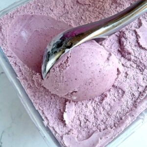 Delicious Mixed berry ice cream scoop in container.