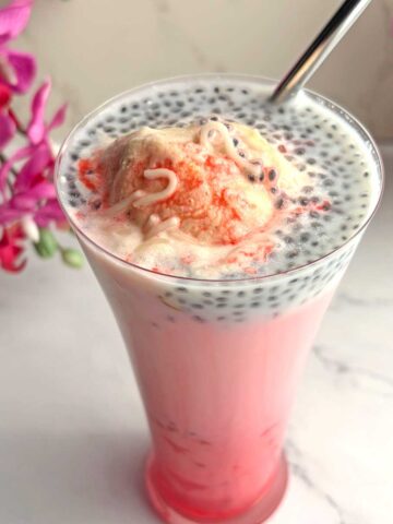 Falooda ice cream in a tall glass with straw.