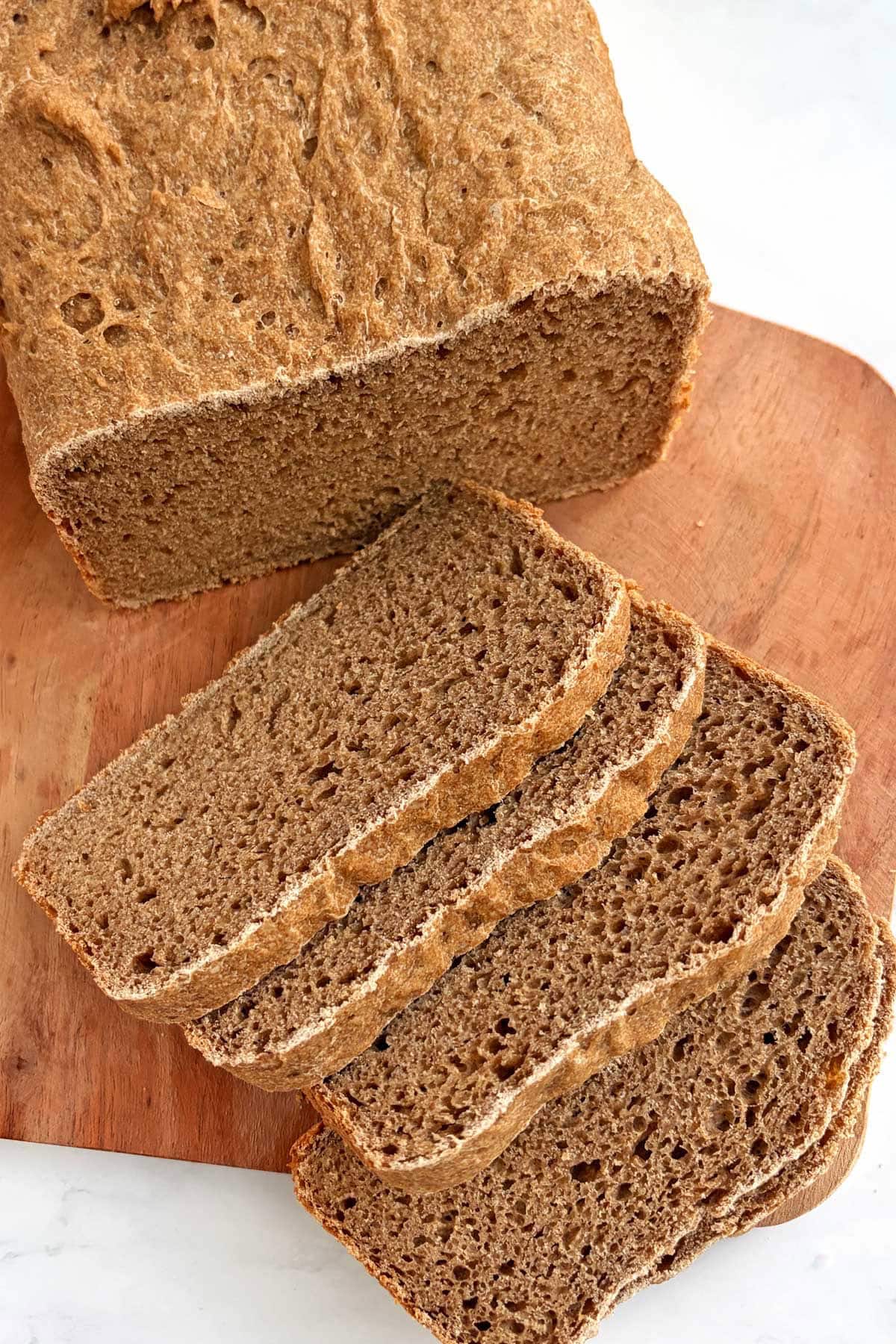 Sprouted wheat flour bread slices on a cutting board.