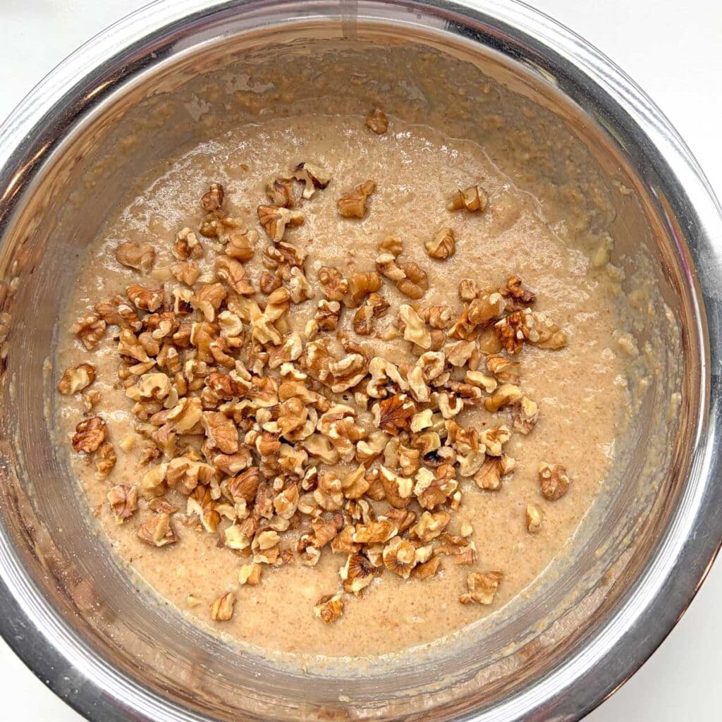 Banana Muffin batter mix with walnut topping in a mixing blow.