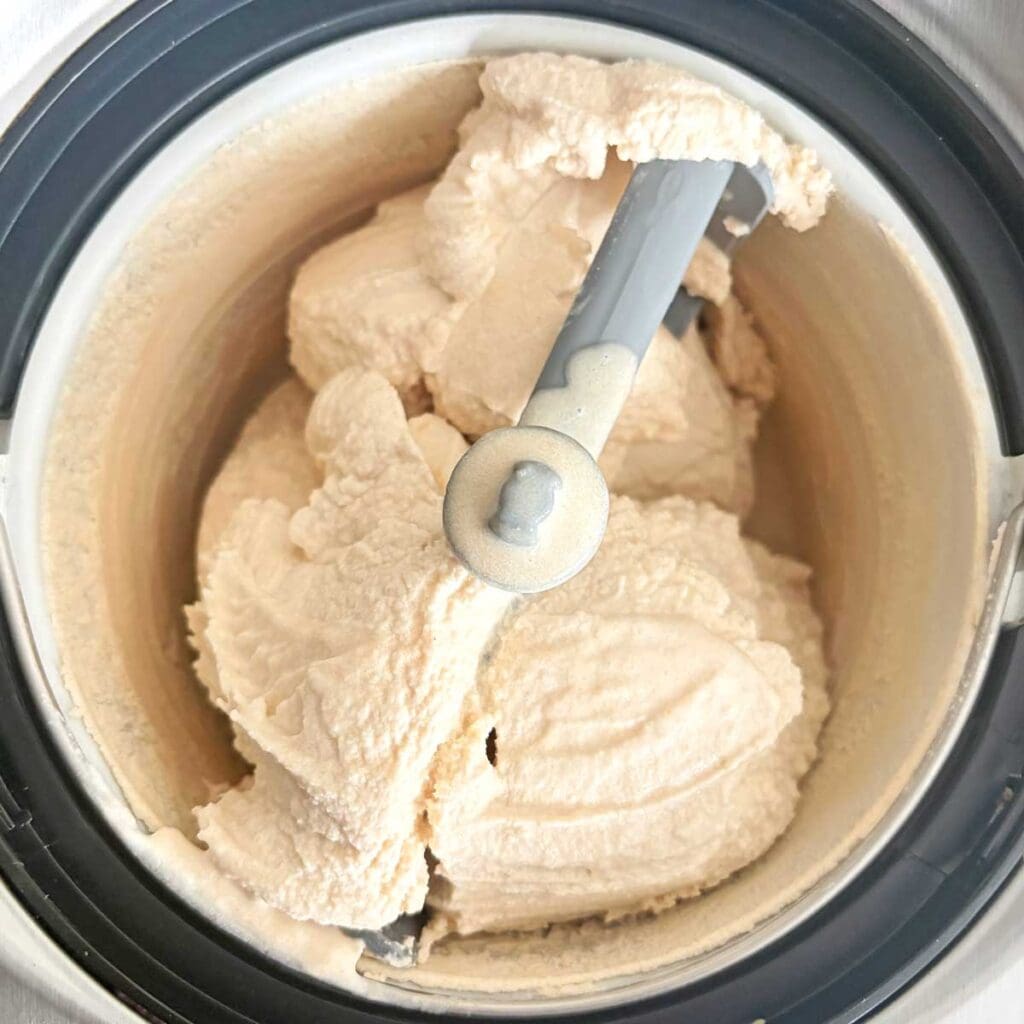 Chikoo ice cream churning in ice cream maker.