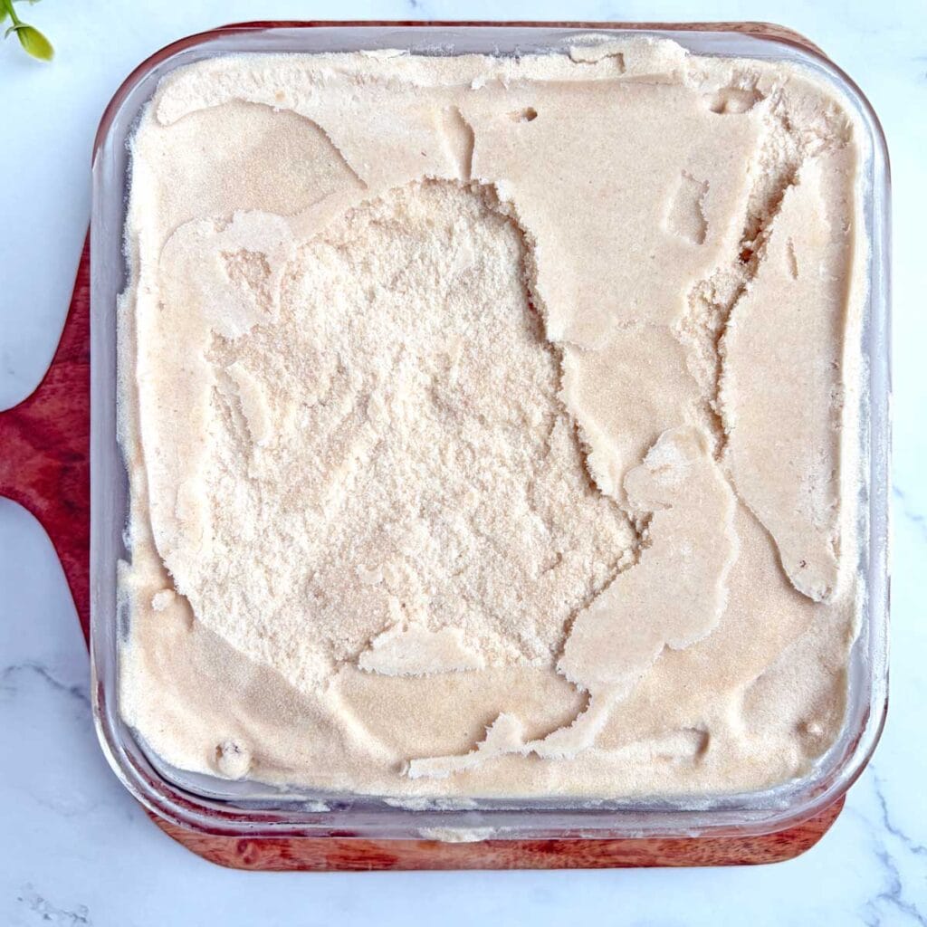 Chikoo ice cream in container.