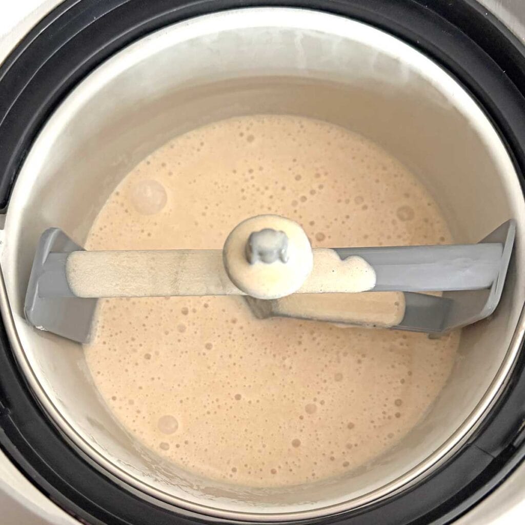 Chikoo ice cream mix in an ice cream maker pan.