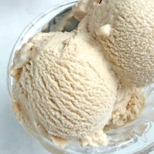 Chikoo ice cream scoops in a glass serving bowl.