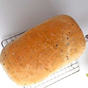 Everything Seasoning bread loaf on cooling rack.