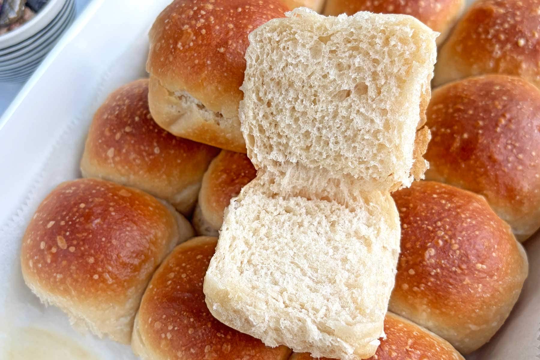 Sourdough dinner rolls in a baking tray.