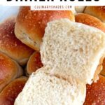 Sourdough dinner rolls sliced in a baking tray.