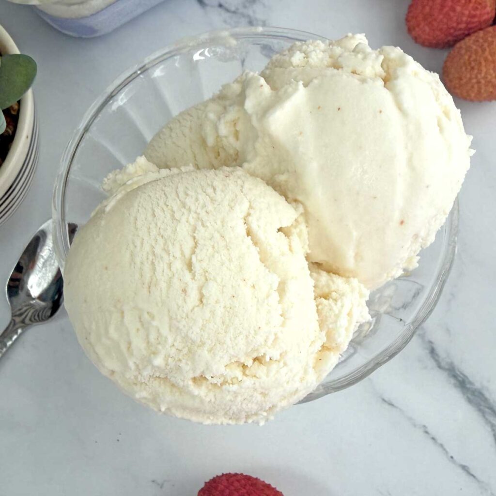 Lychee ice cream scoops in a serving bowl.
