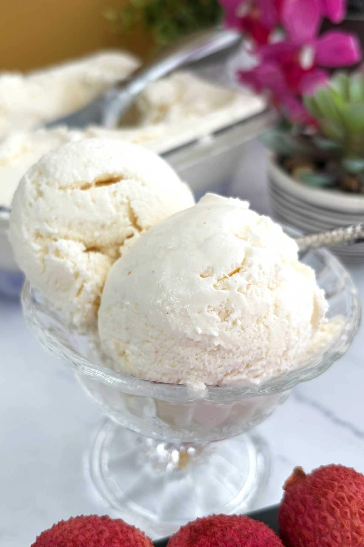 Lychee ice cream scoops in a serving bowl.