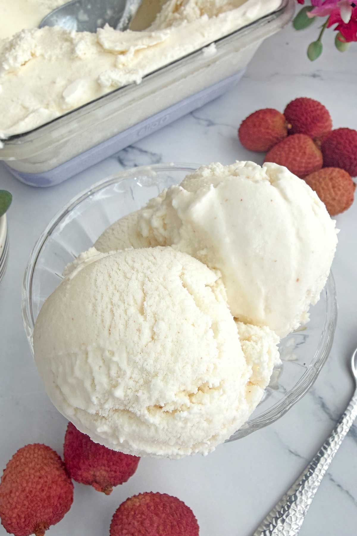 Lychee ice cream scoops in a serving bowl.